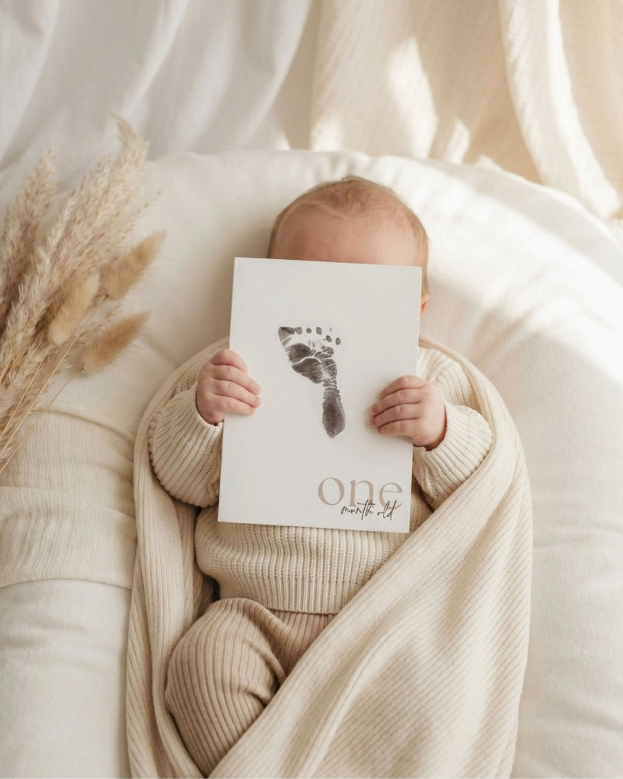 Baby footprint keepsake album with milestone card
